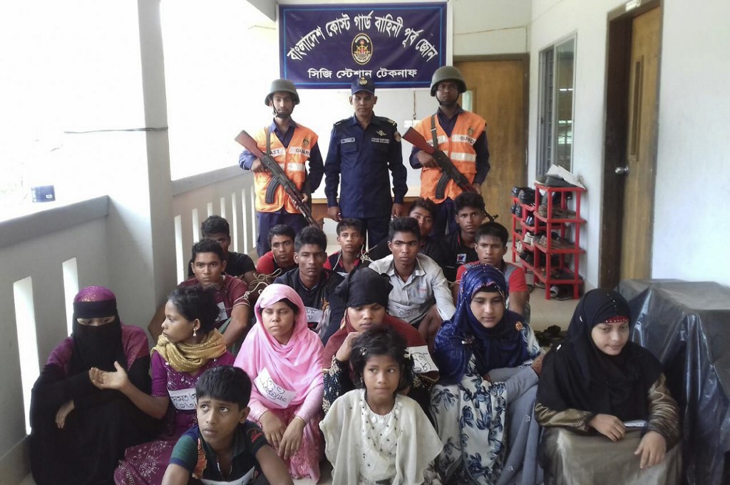 Bangladesh Coast Guard pose for a photo with rescued Rohingya refugees in Teknaf on May 18, 2019. (STR / AFP)