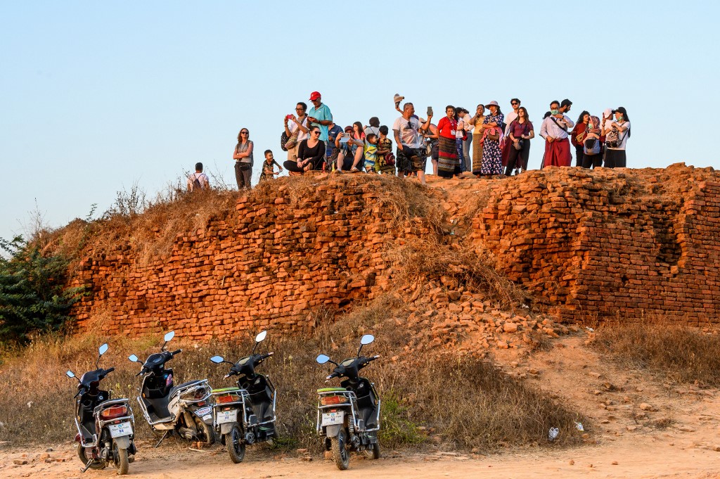 This photograph taken on January 18, 2020 shows tourists watching the sunset in Bagan. (Mladen Antonov / AFP)