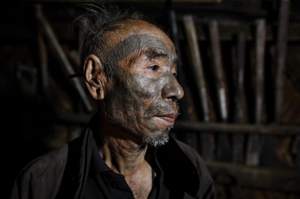 This photo taken on February 9, 2020 shows Nok Tan, 75, a tattooed Konyak tribeman, in his house in a village in Sagaing region of Myanmar, wedged in a semi-autonomous zone near the Indian border. (Photos by Ye Aung Thu / AFP)