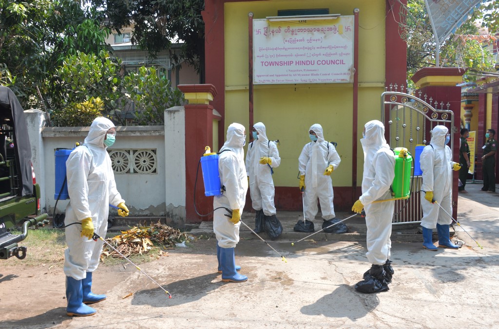 Myanmar military personnel wearing protective clothing prepare to disinfect a Hindu temple as a preventive measure to contain the spread of COVID-19 coronavirus in Naypyidaw on April 1, 2020. (Thet Aung / AFP)