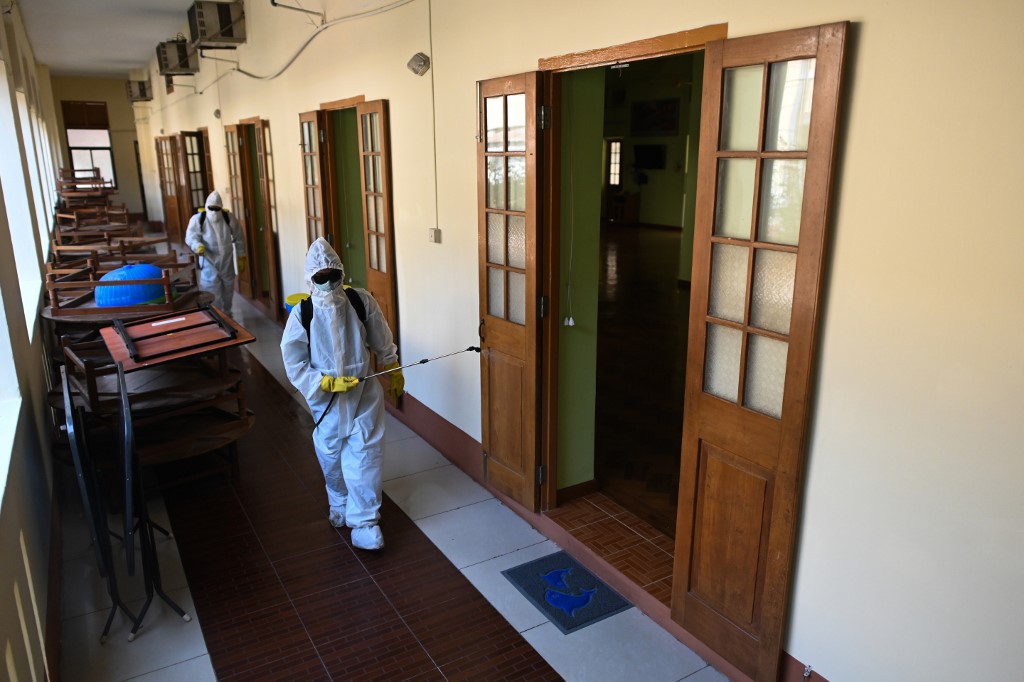Myanmar military personnel wearing protective clothing disinfect a monastery as a preventive measure to contain the spread of COVID-19 coronavirus at Yangon on April 7, 2020. (Ye Aung Thu / AFP)