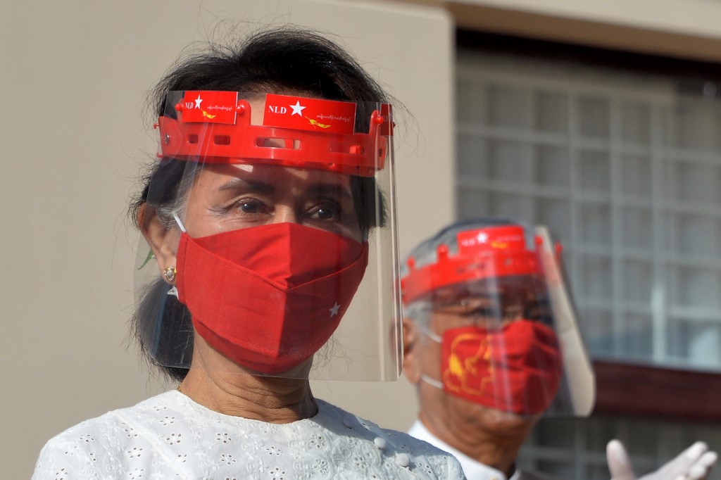 Myanmar's de-facto leader Aung San Suu Kyi wears a face shield and mask as she attends a flag-raising ceremony for the National League for Democracy (NLD) party to mark the first day of election campaigning in Naypyidaw on September 8. (Thet Aung / AFP)