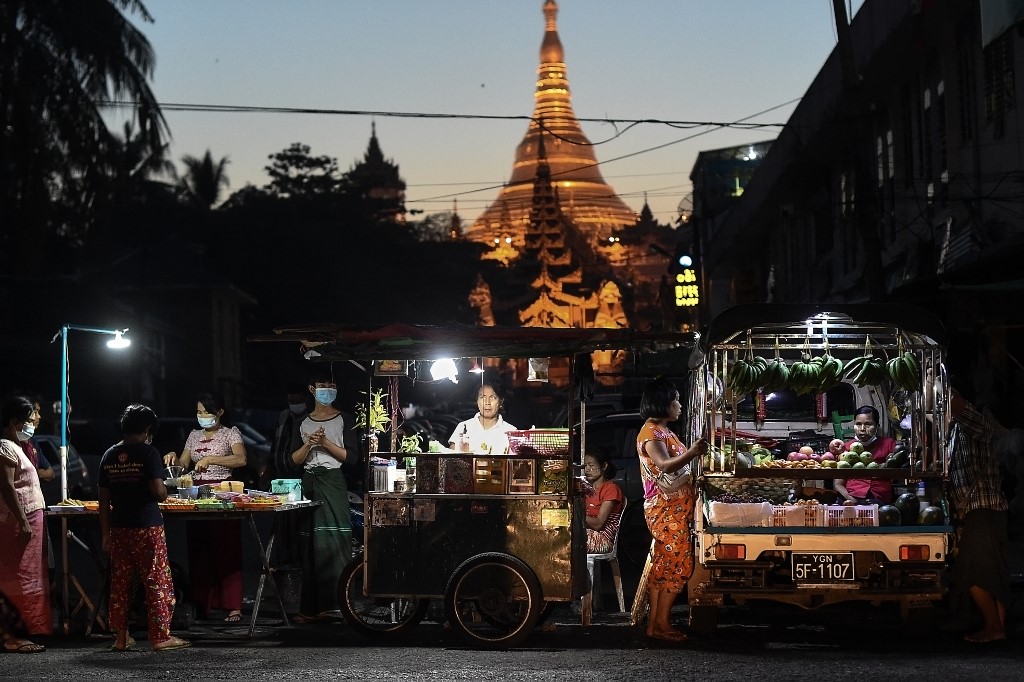 Street vendors wait for customers in front of Shwedagon Pagoda in Yangon. (Ye Aung Thu / AFP)