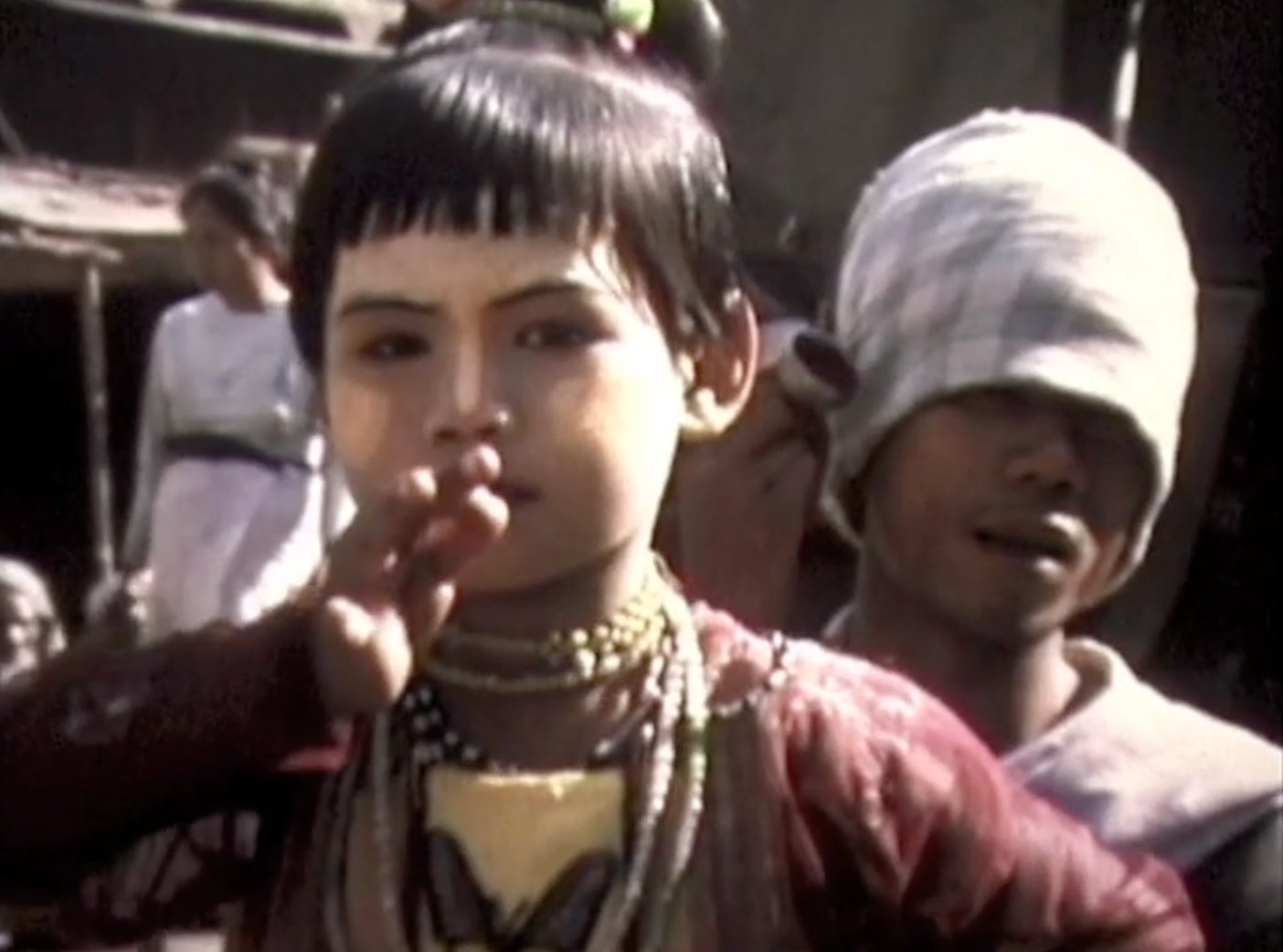 This screenshot from the video shows a child performing a traditional Burmese dance in Mandalay.