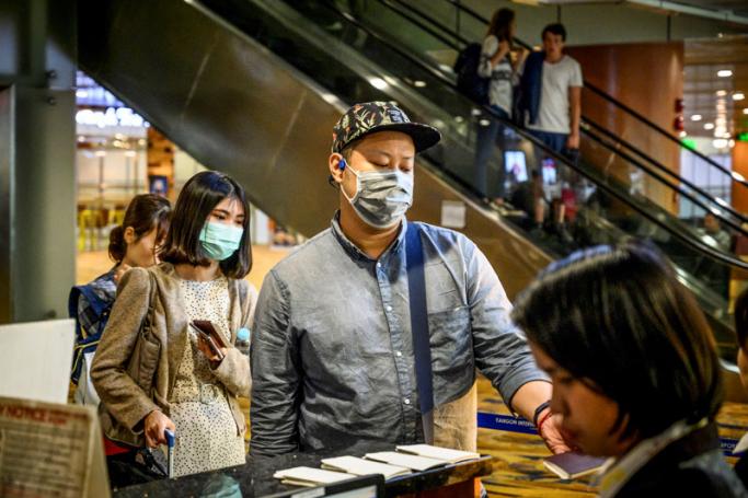 Travellers wearing face masks at Yangon airport. (AFP)