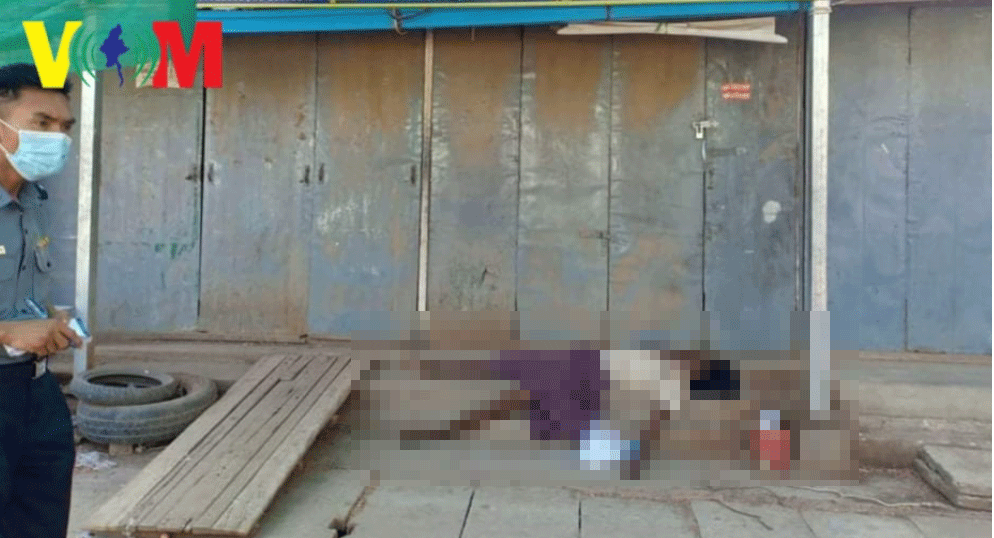 In this photograph published by Voice of Myanmar, the atrophied limbs of a dead man hang over steps at a bus terminal in central Myanmar. A waste collector, police say he died of malnutrition after recycling shops closed due to Covid-19.