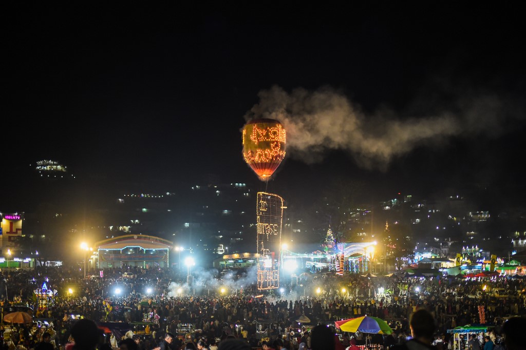 Participants release a hot-air balloon attached with small lanterns during the Tazaungdaing Lighting Festival at Taunggyi in Myanmar's northeastern Shan State. (Ye Aung Thu / AFP)