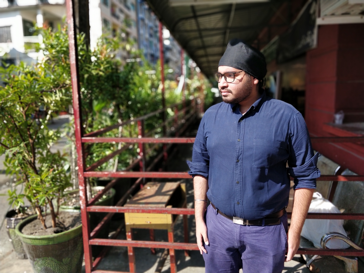 Climate and rights activist Zay Linn Mon stands outside the former Punjab school in Yangon where his brother was told to remove his turban. (Photos by Lorcan Lovett)