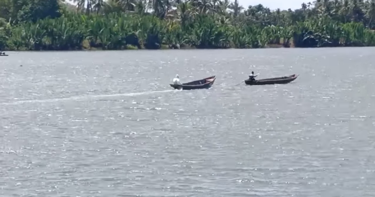 A 25-year-old man who tested positive for Covid-19 travels with his father in the front boat to a hospital in Rakhine state. 