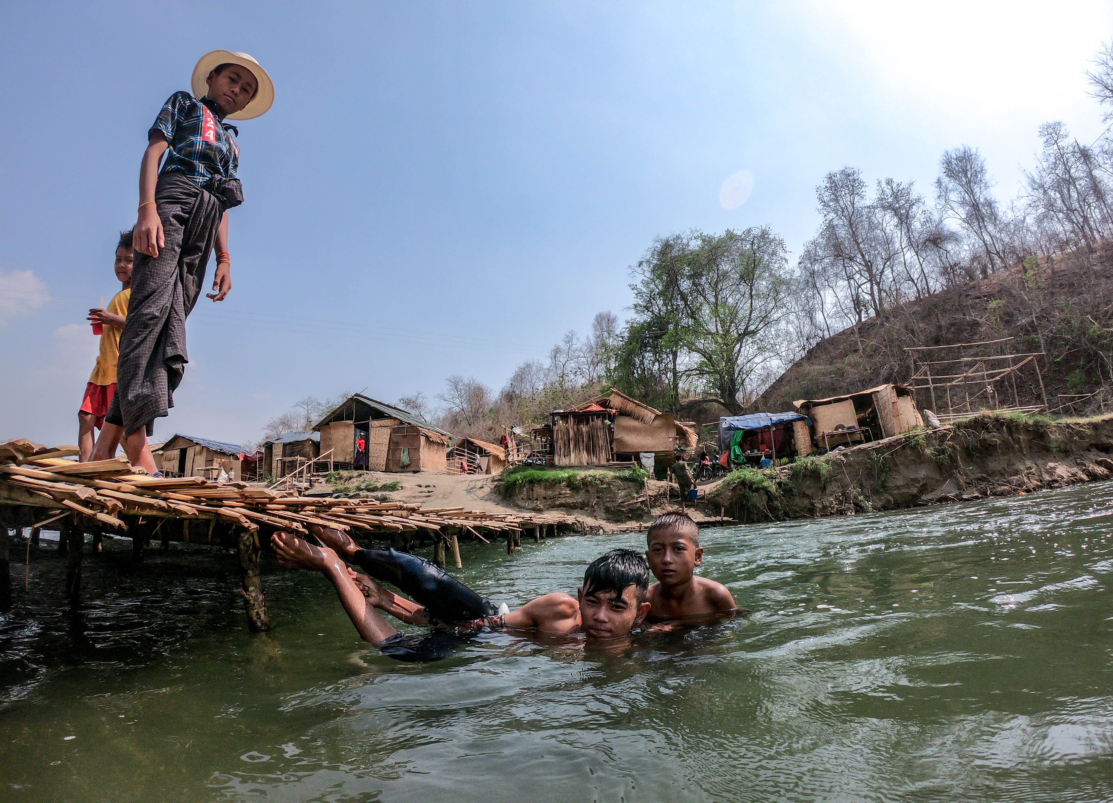 For more than a mile, small huts line the river, partitioned off by bamboo bridges creating numerous self-contained swimming areas. (Dominic Horner)