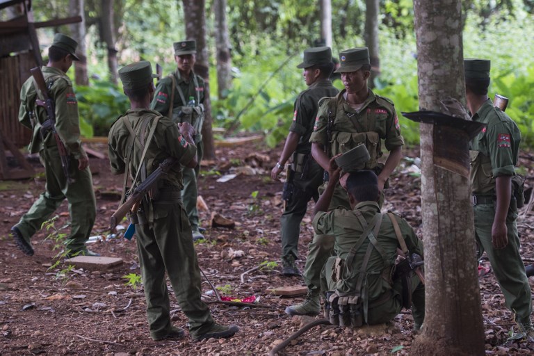 Members of the United Wa State Army taking a rest in the rubber planting in Poung Par Khem region, near the Thailand and Myanmar border on June 26, 2017. (Ye Aung Thu / AFP)