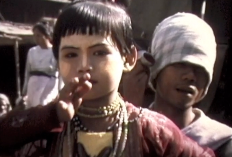 This screenshot from the video shows a child performing a traditional Burmese dance in Mandalay.