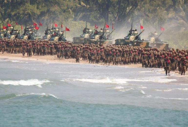 Myanmar military troops and tanks move in formation along the shore during the second day of 'Sin Phyu Shin' joint military exercises in Ayeyarwaddy delta region. (Lynn Bo Bo / AFP)