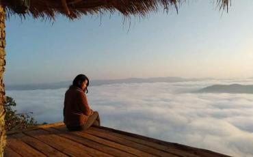 A visitor sits above a blanket of clouds at Cloudy Villa in northern Shan State. (Cloudy Villa / Facebook)