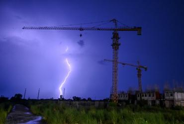 Lightning strikes over a construction site during the sunset in Yangon on June 3, 2020. (Ye Aung Thu / AFP)