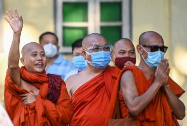 Buddhist monk Wirathu (L) waves to his followers before turning himself in at a Yangon police station on November 2, 2020. (Ye Aung Thu / AFP)