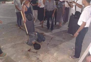 Witnesses and officers crowd around the man after he was shot in Mandalay early Saturday morning. (Supplied / Facebook)